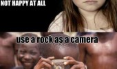 soiled little girl kid not happy african boy rock as camera funny pics pictures pic picture image photo images photos lol